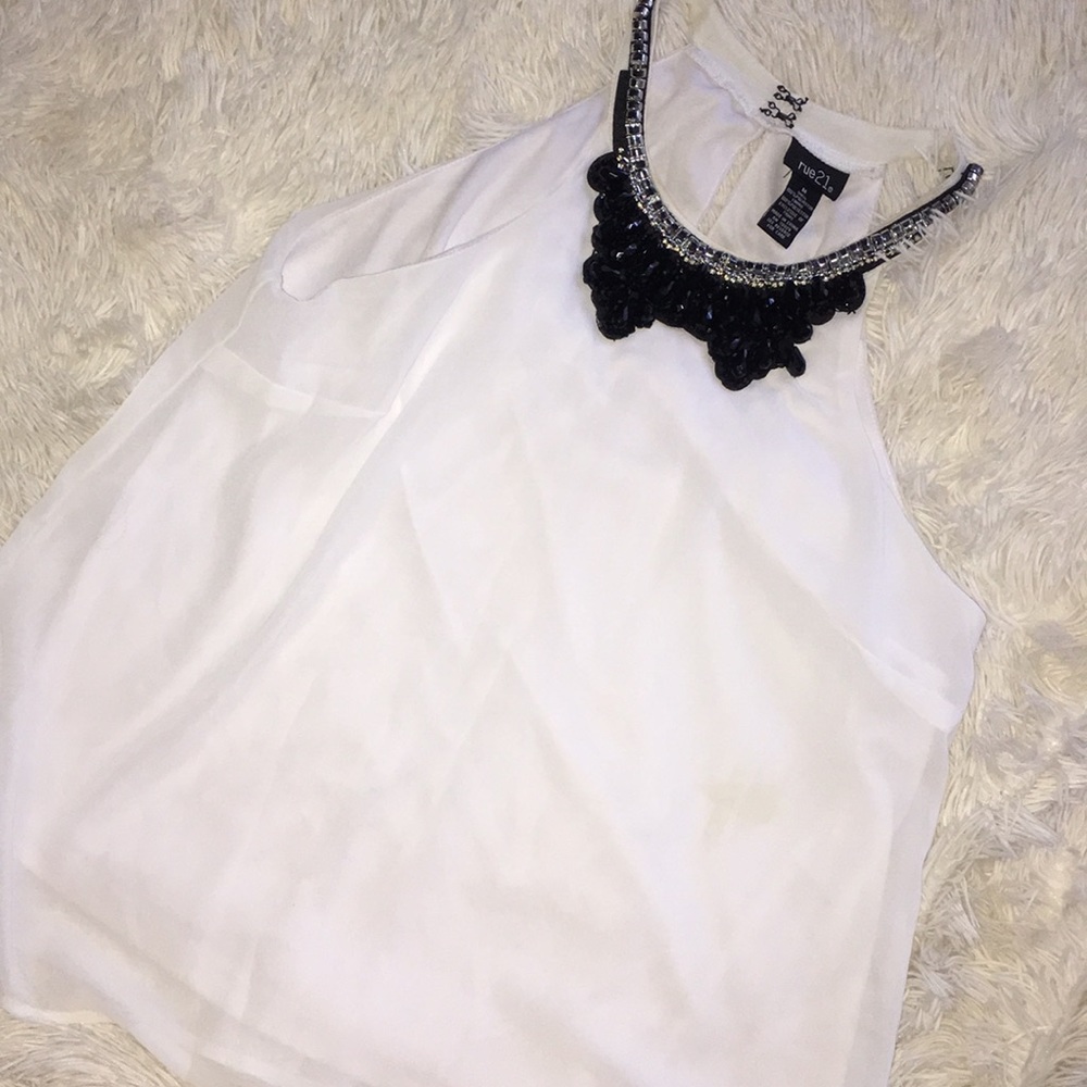 White blouse with black collar.
